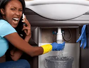 Emergency plumbing repair for a leaking sink drain under a bathroom vanity in Madison, WI